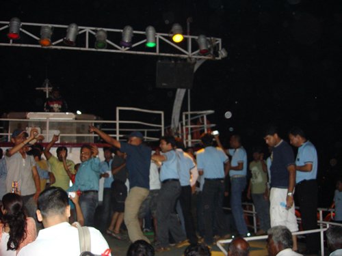 People dancing on a ship deck.
